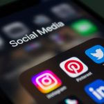 close up of a smartphone screen displaying social media app folder